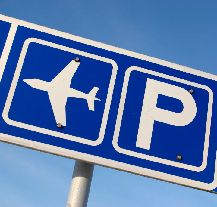 Blue Airport Parking Sign With Clouds In The Background